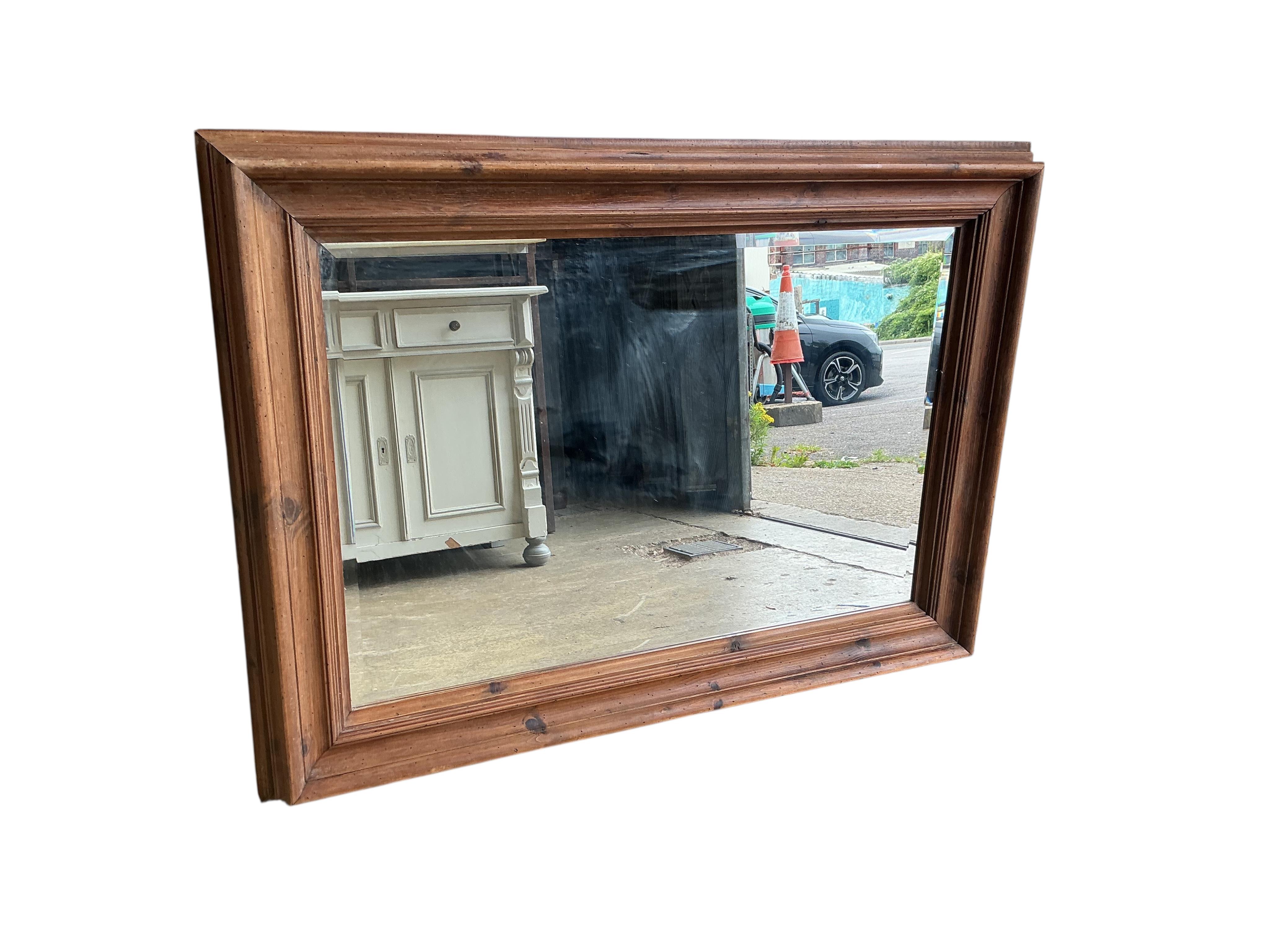 A rectangular pine overmantel mirror, width 114cm, height 82cm
